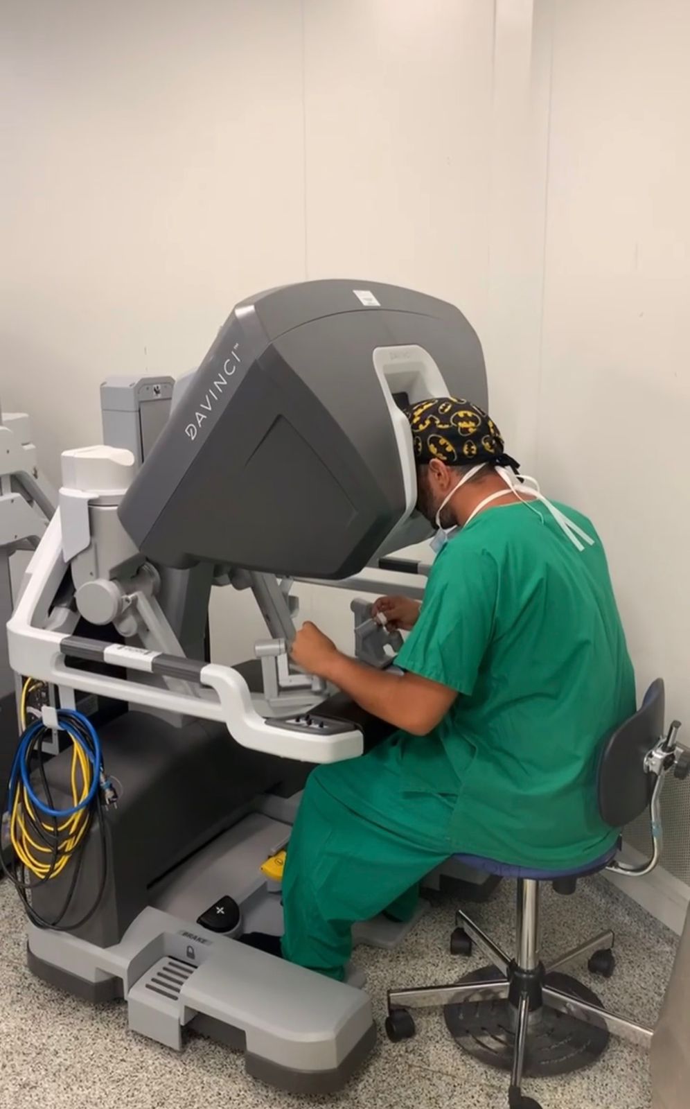 Dr. Joseph Gharios operating with a robotic-assisted surgical system